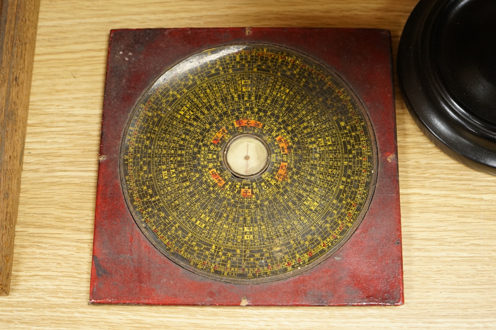 A Geographica 8 inch globe on a turned ebonised wood stand, 39cm high, together with a Chinese ‘Luopan’ compass, for use in feng shui practice.